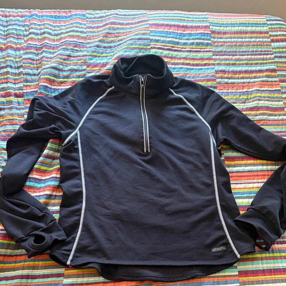 Athleta reflective, long sleeve 1/2 zip  size medium zipper back pocket